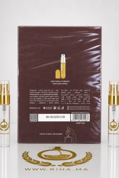 decantage amber oud al haramain perfumes — Flacon de décantage amber oud al haramain perfumes posé sur fond doré — vue 2