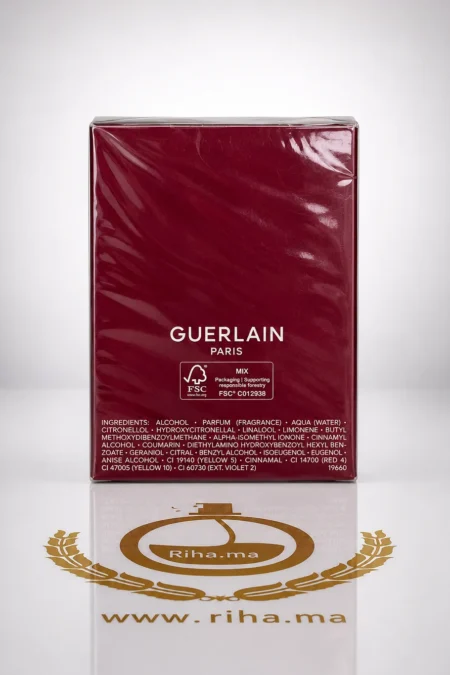 Flacon de habit rouge de guelain parfum posé sur fond rouge élégant — vue 2